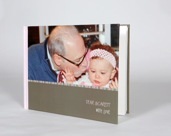 Book with picture of older man kissing baby girl.
